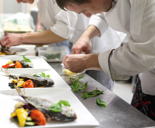 chef plating up in busy restaurant