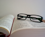 reading glasses on open text book