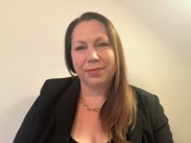 Elysia McCaffrey with long dark hair smiling at the camera