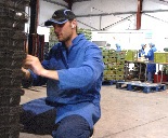 Young man cap kneeling warehouse