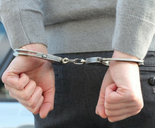 GLAA Man with hands handcuffed behind back