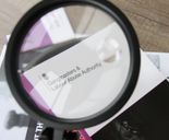 GLAA Magnifying Glass over spot the signs booklet