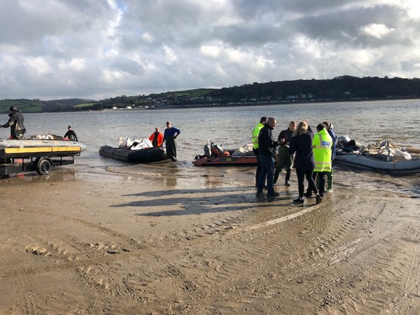 Boats arriving on beach in Carmarthenshire