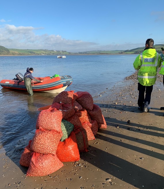 Fishing boat on the beach unloading shellfish