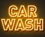 Car wash neon sign on brick wall