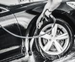 Hand cleaning car wheels using high pressure washer