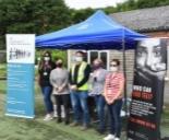GLAA officers and Proforce staff wearing masks beside banners