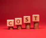 COST word made with wooden blocks on coins