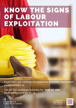 Gloved hand holding safety helmet