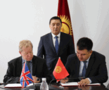 Darryl Dixon signing MOU in Kyrgyzstan