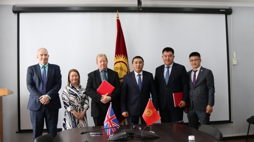 Darryl Dixon signing the agreement in Kyrgyzstan