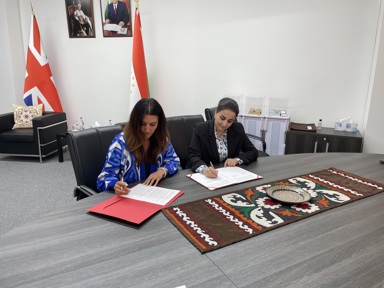 Director of strategy and impact Sam Ireland signing MOU document with her Tajikistan colleague